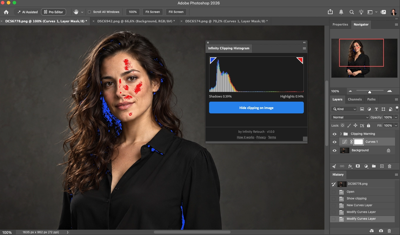 A portrait in Photoshop with the Clipping Warning on: clipped highlights on the face painted red, clipped shadows in the hair and the black shirt painted blue, and the Infinity Clipping Histogram panel showing 0.39% shadows and 0.14% highlights.